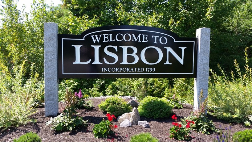 Welcome to Lisbon sign, Incorporated 1799, on granite posts surrounded by landscaped plantings